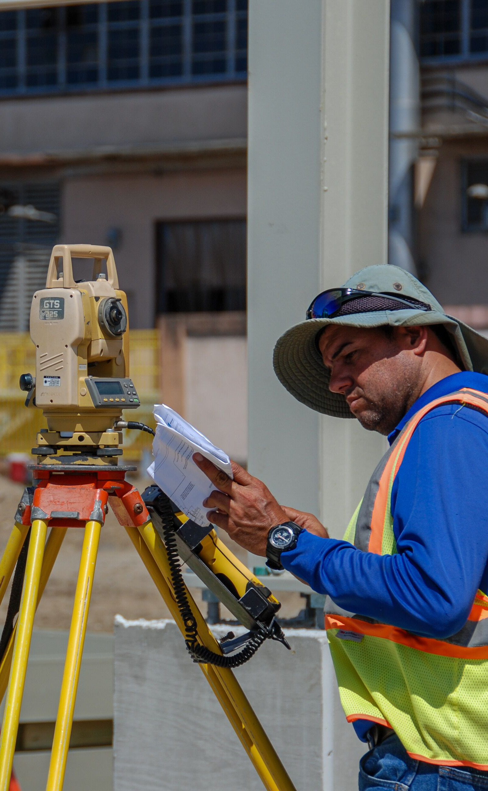 Worker using surveying equipment